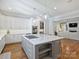 Spacious kitchen featuring a large island with cooktop, stainless steel appliances, and ample counter space at 6314 Saint Stephen Ln, Charlotte, NC 28210