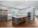 Bright kitchen features a large island with seating, stainless steel appliances, and white cabinetry at 6314 Saint Stephen Ln, Charlotte, NC 28210
