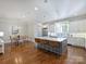 Bright, open kitchen with a large island, stainless steel appliances, and hardwood floors at 6314 Saint Stephen Ln, Charlotte, NC 28210