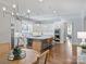 Stunning kitchen featuring a large island, stainless steel appliances, and a dining area at 6314 Saint Stephen Ln, Charlotte, NC 28210