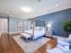 Bright main bedroom with hardwood floors, a four-poster bed, and stylish decor at 6314 Saint Stephen Ln, Charlotte, NC 28210