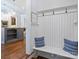 Welcoming mudroom with a bench, coat hooks, and storage leading to the kitchen at 6314 Saint Stephen Ln, Charlotte, NC 28210