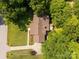 Eye-level aerial showing a home and deck shrouded by mature trees and a green manicured lawn with a wood fence at 637 Freemont Dr, Lancaster, SC 29720