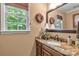 Well-lit bathroom with granite countertop, wood vanity, and large mirror at 637 Freemont Dr, Lancaster, SC 29720