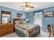 Comfortable blue bedroom with a wooden bed frame, quilt, and natural light at 637 Freemont Dr, Lancaster, SC 29720