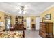 Bright yellow bedroom with a large dresser and mirror, complemented by floral curtains and a comfortable bed at 637 Freemont Dr, Lancaster, SC 29720