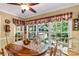 Bright dining room with large windows overlooking the backyard and a ceiling fan at 637 Freemont Dr, Lancaster, SC 29720
