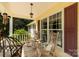 Cozy front porch with rocking chairs, decorative pillows, and hanging lantern at 637 Freemont Dr, Lancaster, SC 29720