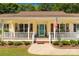 Inviting front porch with white railings, shutters, and a blue front door at 637 Freemont Dr, Lancaster, SC 29720