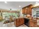 Bright kitchen with wood cabinets, granite countertops, and a view to the breakfast nook at 637 Freemont Dr, Lancaster, SC 29720