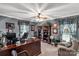 Well-lit office featuring a large desk, built-in shelving, and comfortable seating by the window at 637 Freemont Dr, Lancaster, SC 29720