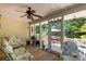 Relaxing screened-in porch with ceiling fan and view of the wooded backyard at 637 Freemont Dr, Lancaster, SC 29720
