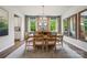 Bright dining room with modern table, natural light from windows, and stylish light fixture at 6514 Alanbrook Rd, Charlotte, NC 28215