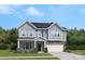 New construction home showcases a charming two-story design and welcoming landscaped front yard at 6514 Alanbrook Rd, Charlotte, NC 28215