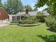 Expansive backyard featuring mature trees, manicured lawn, and charming landscaping for outdoor enjoyment at 7118 Powder Mill Pl, Charlotte, NC 28277