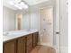 Bathroom featuring dual sink vanity, tile flooring, and a separate toilet room at 7118 Powder Mill Pl, Charlotte, NC 28277