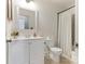 Bathroom with a decorative mirror, white vanity, and a shower-tub combination at 7118 Powder Mill Pl, Charlotte, NC 28277