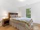 Cozy bedroom filled with light from a large window, complete with a floral quilt at 7118 Powder Mill Pl, Charlotte, NC 28277