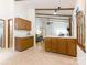 Bright kitchen features classic wood cabinets and tiled floors, flowing into the living area at 7118 Powder Mill Pl, Charlotte, NC 28277