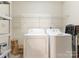 Functional laundry area featuring a washer, dryer, and shelving for storage at 7118 Powder Mill Pl, Charlotte, NC 28277