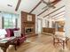 Cozy living room with exposed beams, brick fireplace, and hardwood floors at 7118 Powder Mill Pl, Charlotte, NC 28277