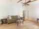 Comfortable living area with hardwood floors, ceiling fan, and views of the home's airy layout at 7118 Powder Mill Pl, Charlotte, NC 28277