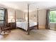 Spacious bedroom with hardwood floors, crown molding, and large windows for natural light at 7118 Powder Mill Pl, Charlotte, NC 28277