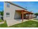 Back exterior view of home with screened porch and concrete patio at 722 Overlook Rd, Lowell, NC 28098