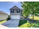 Charming two-story home featuring a two-car garage, well-manicured lawn, and a welcoming front porch at 722 Overlook Rd, Lowell, NC 28098