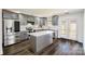 Modern kitchen with stainless steel appliances, gray cabinets, white countertops, and center island at 722 Overlook Rd, Lowell, NC 28098