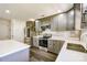 Modern kitchen with stainless steel appliances, white countertops, stylish backsplash, and ample cabinet space at 722 Overlook Rd, Lowell, NC 28098