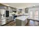 Modern kitchen featuring stainless steel appliances, gray cabinets, white countertops, and center island at 722 Overlook Rd, Lowell, NC 28098