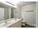 Bathroom featuring dual sinks, white cabinets, hard surface flooring, and a shower-tub combo at 722 Overlook Rd, Lowell, NC 28098