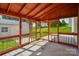 Enclosed porch featuring a wood beamed ceiling and views of the yard at 722 Overlook Rd, Lowell, NC 28098