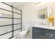 Updated bathroom featuring modern shower with glass door, marble tiles, and stylish vanity with round mirror at 803 Irene Ave, Kannapolis, NC 28083