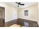 Cozy bedroom with hardwood floors, a ceiling fan, and a door leading to the ensuite bathroom at 803 Irene Ave, Kannapolis, NC 28083