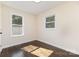 Well-lit bedroom featuring hardwood floors and large windows, creating a cozy and inviting space at 803 Irene Ave, Kannapolis, NC 28083