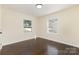 Bright bedroom with gleaming hardwood floors and windows offering a pleasing view of the outdoors at 803 Irene Ave, Kannapolis, NC 28083