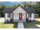 Charming one-story home featuring a red front door, black roof, and a well-manicured lawn at 803 Irene Ave, Kannapolis, NC 28083