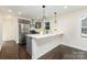 Modern kitchen featuring gray cabinets, stainless steel appliances, and a stylish breakfast bar at 803 Irene Ave, Kannapolis, NC 28083