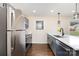 Efficient kitchen layout with stainless steel refrigerator, gray cabinets, and white quartz counters at 803 Irene Ave, Kannapolis, NC 28083