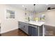Well-lit kitchen with an island, stainless steel dishwasher, and stylish pendant lighting at 803 Irene Ave, Kannapolis, NC 28083