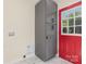 Convenient laundry room with built-in storage cabinets and a bright red exterior door at 803 Irene Ave, Kannapolis, NC 28083