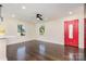 Inviting living room with hardwood floors, bright windows, and a vibrant red front door at 803 Irene Ave, Kannapolis, NC 28083