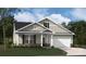 Charming one-story home with a gray exterior, a two-car garage, and a beautifully landscaped front yard at 916 Exeter Dr, Sherrills Ford, NC 28673