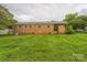 Backyard with brick house and green grass at 1019 Carmel Dr, Gastonia, NC 28056