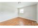 This bedroom features hardwood floors and a bright window at 1019 Carmel Dr, Gastonia, NC 28056