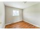 The bedroom has hardwood flooring and a large window for natural light at 1019 Carmel Dr, Gastonia, NC 28056