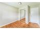 This bedroom features a mirrored closet door and hardwood flooring at 1019 Carmel Dr, Gastonia, NC 28056