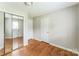 Bedroom featuring mirrored closet doors and hardwood floors at 1019 Carmel Dr, Gastonia, NC 28056